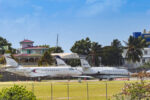 Business jets parked at a Caribbean airport during peak travel season